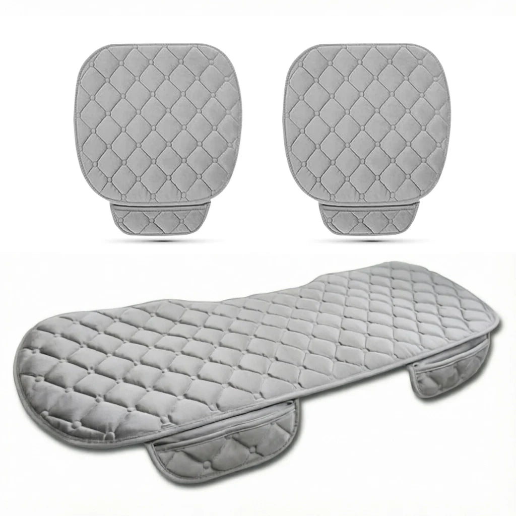 Set of gray quilted seat covers for a motorcycle on a white background