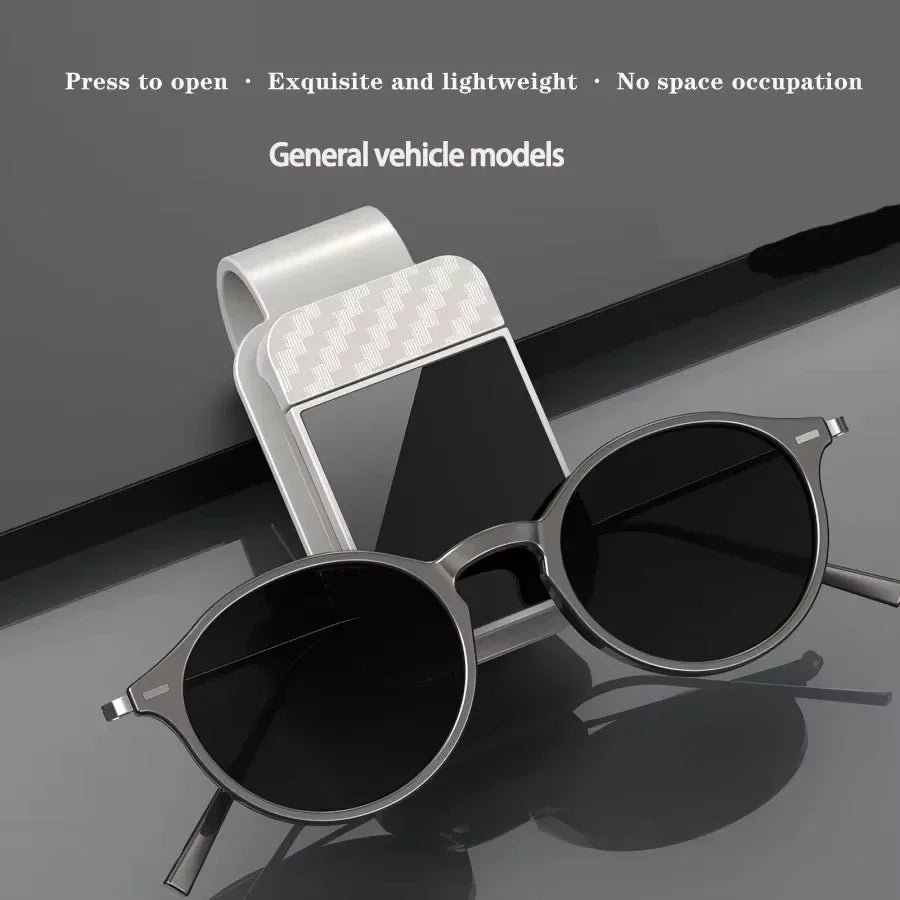 Sunglasses with a car mount on a reflective surface, featuring text about product features.
