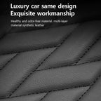 Close-up of quilted black leather material with text on a black background